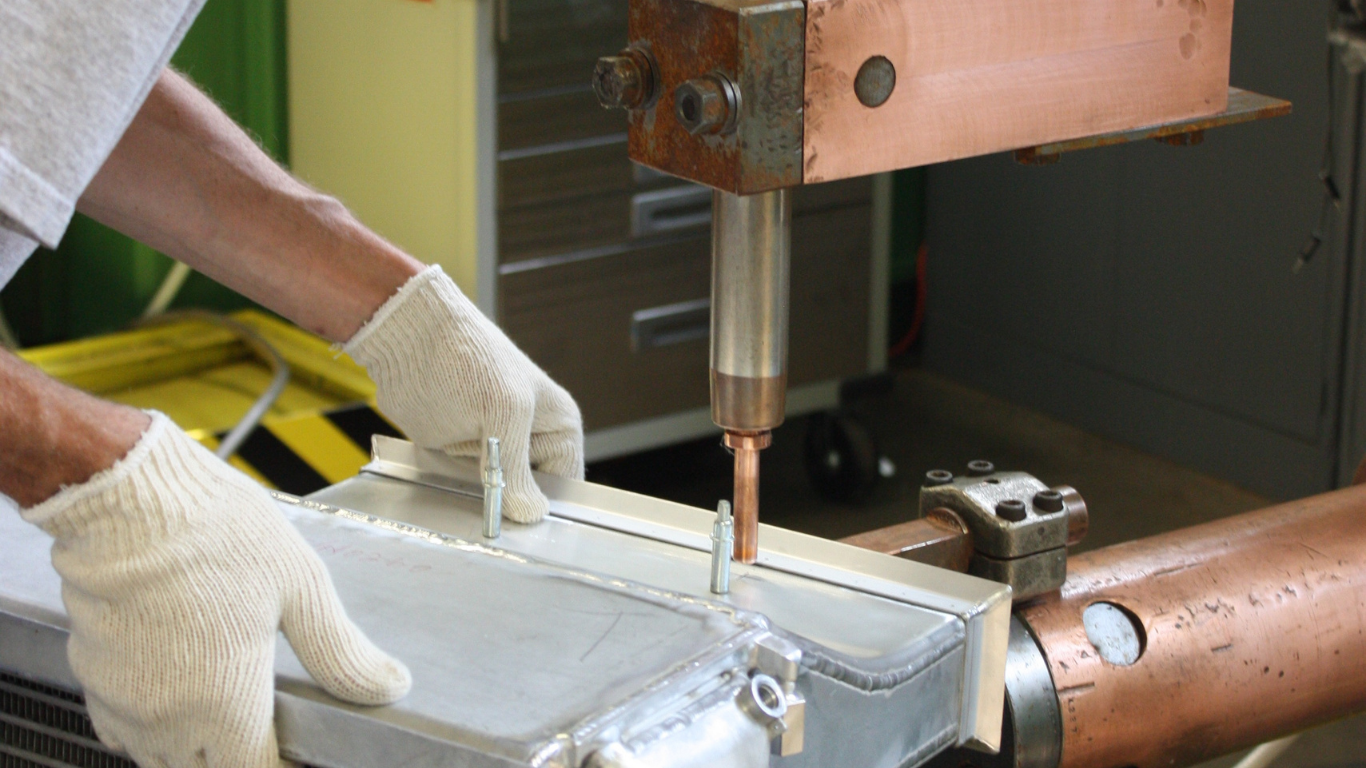 Detailed view of an aircraft duct repair featuring multiple resistance spot welds